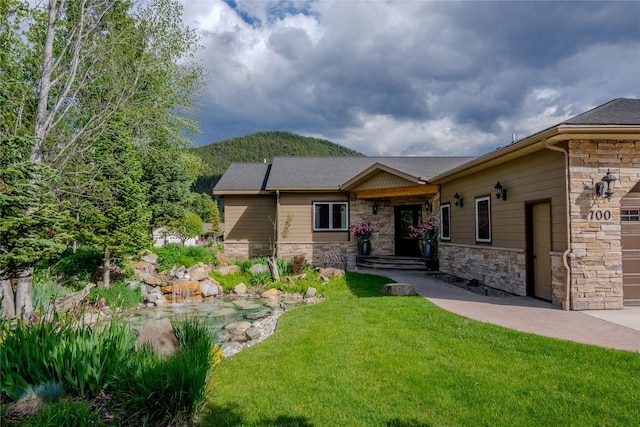 700 Airfield Rd, Libby, MT 59923 - view of front of property featuring stone siding, a front lawn, and a mountain view