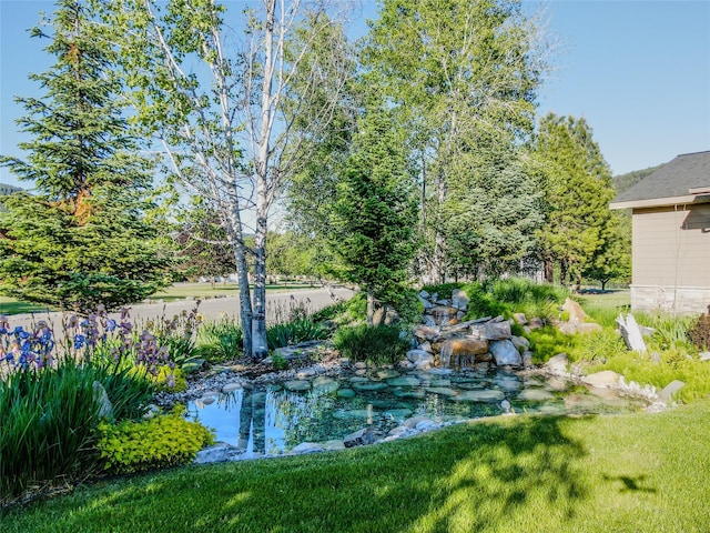 700 Airfield Rd, Libby, MT 59923 - view of green lawn featuring a garden pond