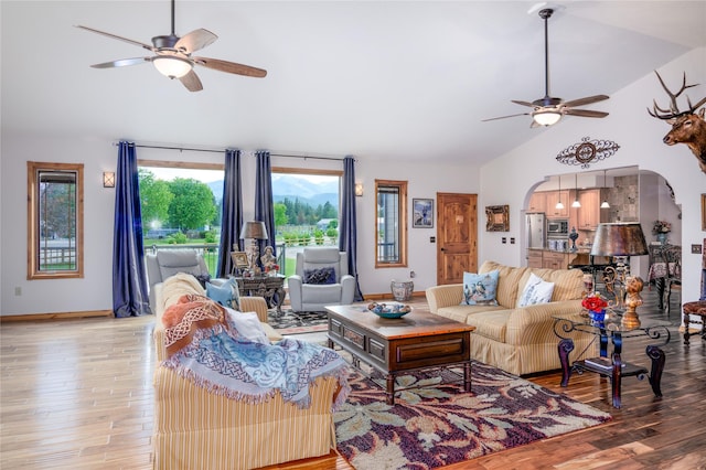 700 Airfield Rd, Libby, MT 59923 - living area featuring a ceiling fan, arched walkways, light wood finished floors, high vaulted ceiling, and baseboards