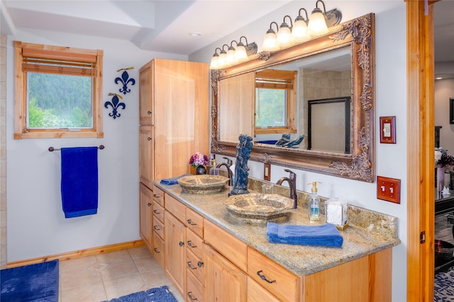 700 Airfield Rd, Libby, MT 59923 - full bath with double vanity, tile patterned flooring, and baseboards
