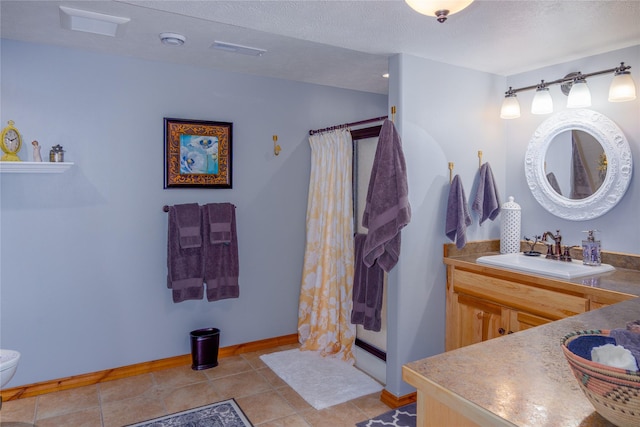 700 Airfield Rd, Libby, MT 59923 - full bath with vanity, a stall shower, toilet, baseboards, and a textured ceiling