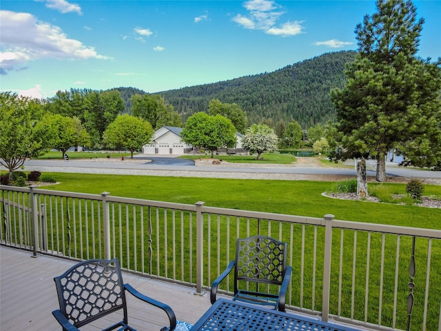 700 Airfield Rd, Libby, MT 59923 - deck featuring a view of trees, a mountain view, and a yard