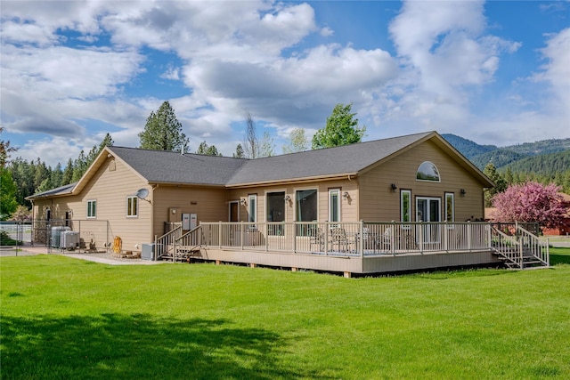 700 Airfield Rd, Libby, MT 59923 - rear view of house featuring a deck with mountain view and central AC unit
