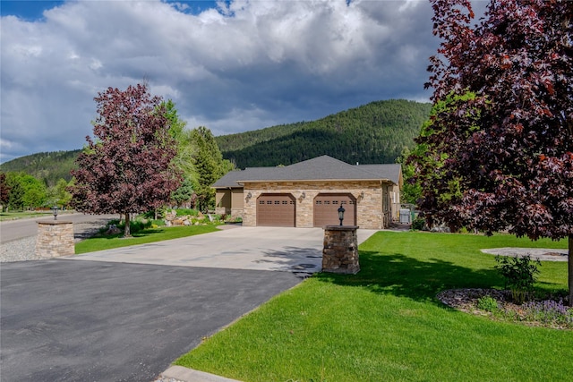 700 Airfield Rd, Libby, MT 59923 - single story home featuring a mountain view, concrete driveway, a front yard, and a garage