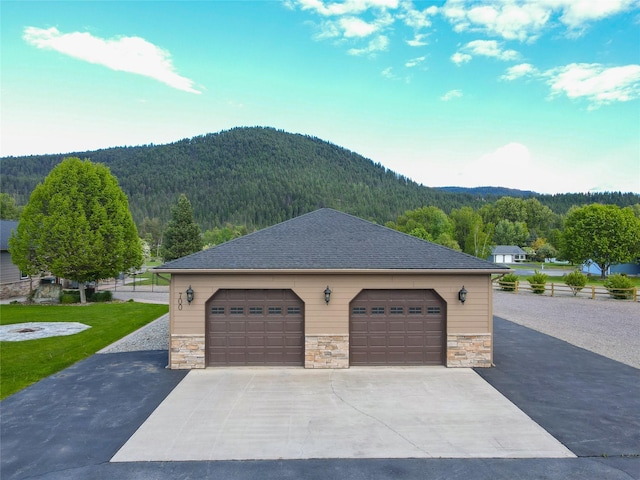 700 Airfield Rd, Libby, MT 59923 - detached garage featuring a mountain view and a wooded view