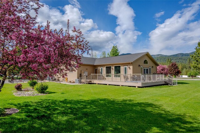 700 Airfield Rd, Libby, MT 59923 - rear view of property featuring a lawn and a deck with mountain view