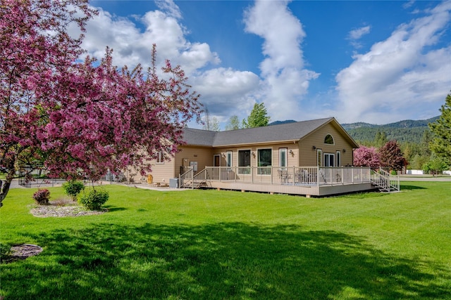 700 Airfield Rd, Libby, MT 59923 - rear view of property featuring a lawn and a deck with mountain view