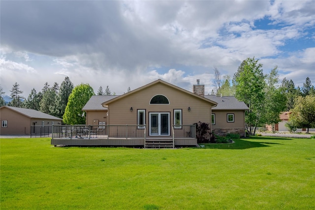 700 Airfield Rd, Libby, MT 59923 - rear view of property featuring a lawn, a wooden deck, and a chimney