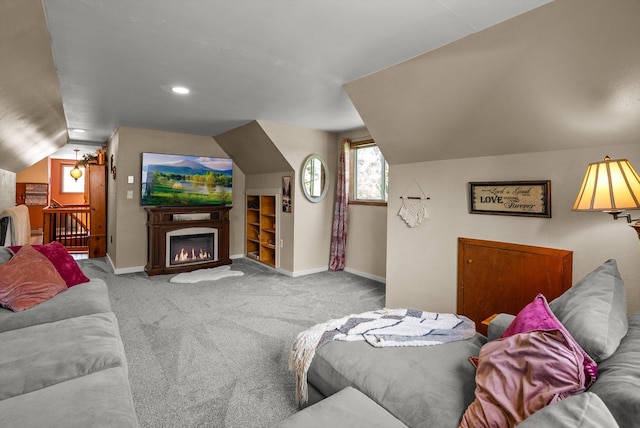 33893 Redgate Dr, Bigfork, MT 59911 - carpeted living area with lofted ceiling and a glass covered fireplace