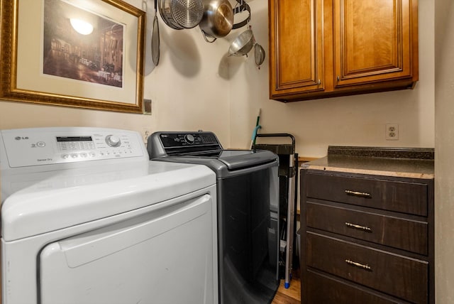33893 Redgate Dr, Bigfork, MT 59911 - washroom with cabinet space and washing machine and clothes dryer