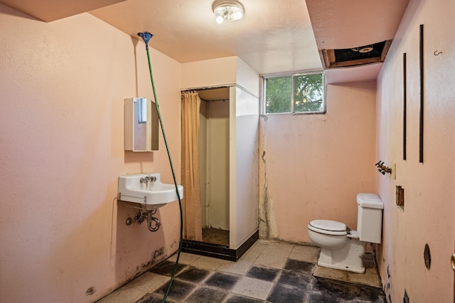 2015 Tower St, Missoula, MT 59804 - bathroom featuring tile patterned floors, toilet, and a stall shower