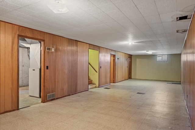 2015 Tower St, Missoula, MT 59804 - basement featuring wooden walls, stairway, and light floors