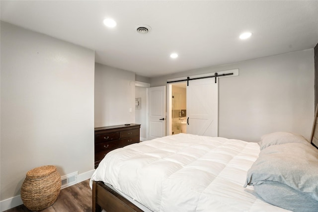 1296 Bighorn Rd, Helena, MT 59602 - bedroom featuring baseboards, wood finished floors, a barn door, and recessed lighting
