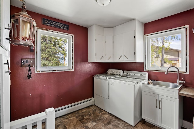 151 6th Ln NE, Fairfield, MT 59436 - washroom featuring cabinet space, a baseboard heating unit, separate washer and dryer, and healthy amount of natural light