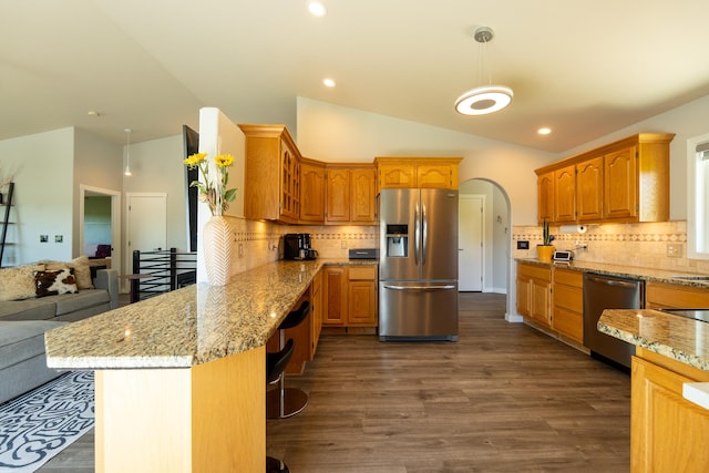 4134 Fox Ridge Dr, Helena, MT 59602 - kitchen with stainless steel appliances, a peninsula, vaulted ceiling, glass insert cabinets, and dark wood-style floors