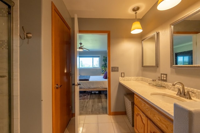4134 Fox Ridge Dr, Helena, MT 59602 - full bathroom featuring vanity, connected bathroom, baseboards, tile patterned flooring, and a shower with shower door
