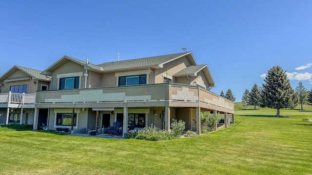4134 Fox Ridge Dr, Helena, MT 59602 - rear view of house featuring stucco siding and a lawn