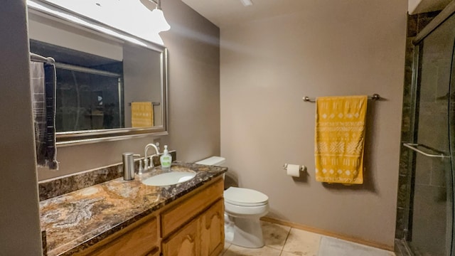 4134 Fox Ridge Dr, Helena, MT 59602 - bathroom featuring toilet, vanity, tile patterned floors, tiled shower, and baseboards