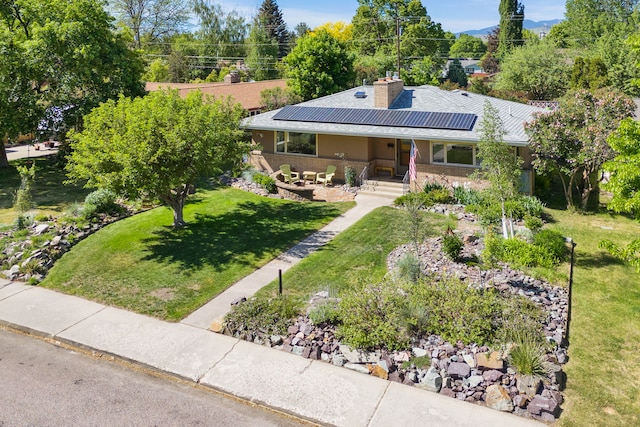 630 Woodworth Ave, Missoula, MT 59801 - view of front of property featuring solar panels, a front lawn, a chimney, and a porch
