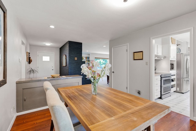 630 Woodworth Ave, Missoula, MT 59801 - dining area featuring light wood finished floors and a fireplace