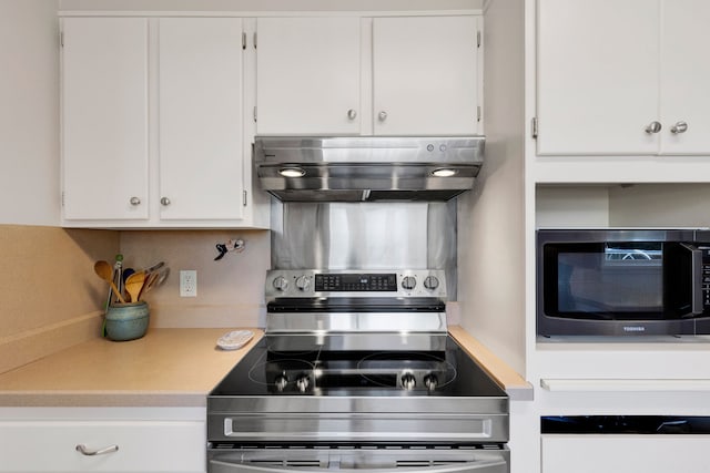 630 Woodworth Ave, Missoula, MT 59801 - kitchen with extractor fan, light countertops, white cabinets, and stainless steel range with electric cooktop