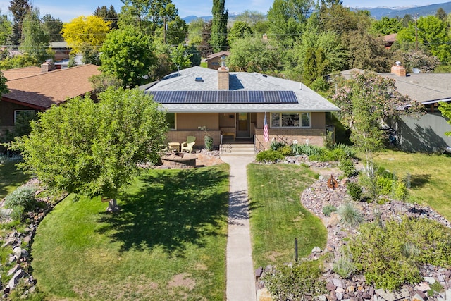 630 Woodworth Ave, Missoula, MT 59801 - rear view of property featuring solar panels, a yard, and a chimney