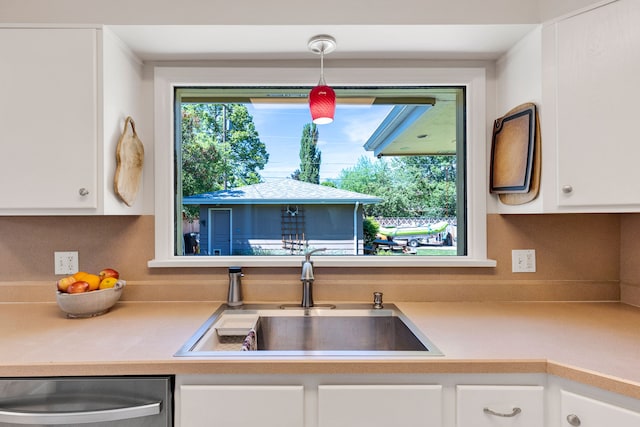 630 Woodworth Ave, Missoula, MT 59801 - kitchen featuring stainless steel dishwasher, white cabinets, and light countertops