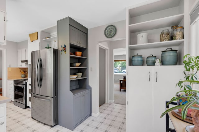 630 Woodworth Ave, Missoula, MT 59801 - kitchen with stainless steel appliances, open shelves, light floors, light countertops, and white cabinetry