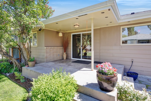 630 Woodworth Ave, Missoula, MT 59801 - view of exterior entry with a patio area and brick siding