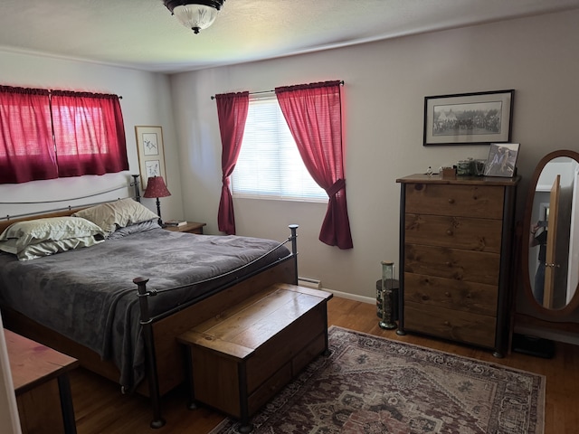 3 Rosebud Ln, Missoula, MT 59801 - bedroom featuring wood finished floors, a baseboard heating unit, and baseboards