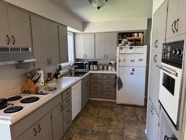 3 Rosebud Ln, Missoula, MT 59801 - kitchen with white appliances, under cabinet range hood, a sink, stone finish floors, and light countertops