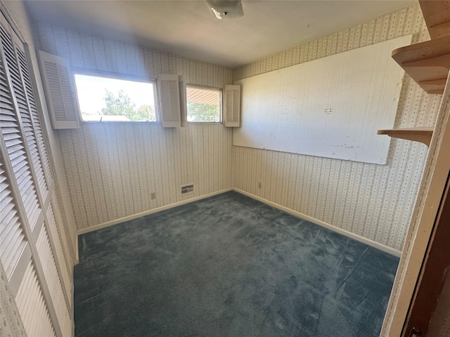 1030 Washington Ave, Havre, MT 59501 - unfurnished bedroom with wallpapered walls, carpet, and baseboards
