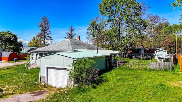 107 7th Ave NW, Ronan, MT 59864 - view of property exterior featuring driveway, roof with shingles, and a chimney
