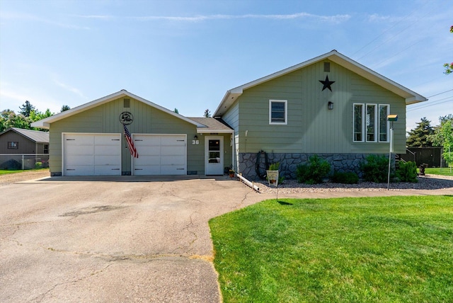 36 Winchester St, Kalispell, MT 59901 - tri-level home with asphalt driveway and a garage