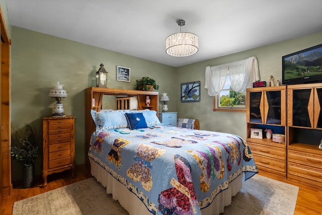 36 Winchester St, Kalispell, MT 59901 - bedroom featuring wood finished floors and a chandelier