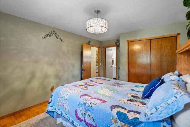 36 Winchester St, Kalispell, MT 59901 - bedroom featuring wood finished floors, baseboards, a chandelier, and a closet