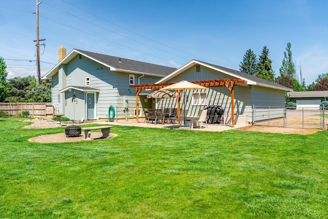 36 Winchester St, Kalispell, MT 59901 - rear view of property featuring a fire pit, a chimney, a pergola, a patio, and a gate