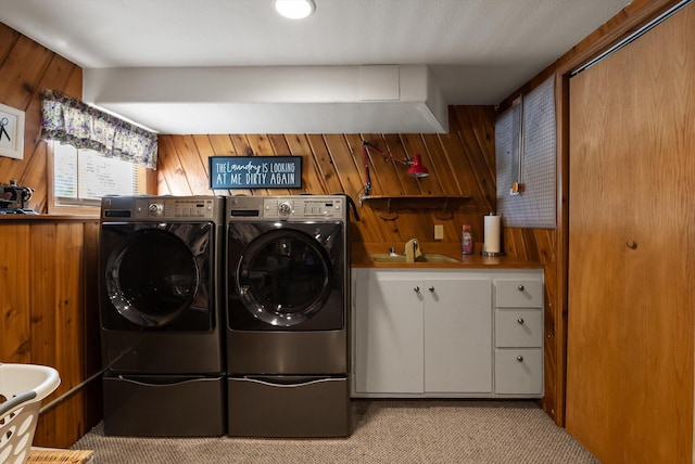 36 Winchester St, Kalispell, MT 59901 - laundry area with cabinet space, separate washer and dryer, wooden walls, and light carpet