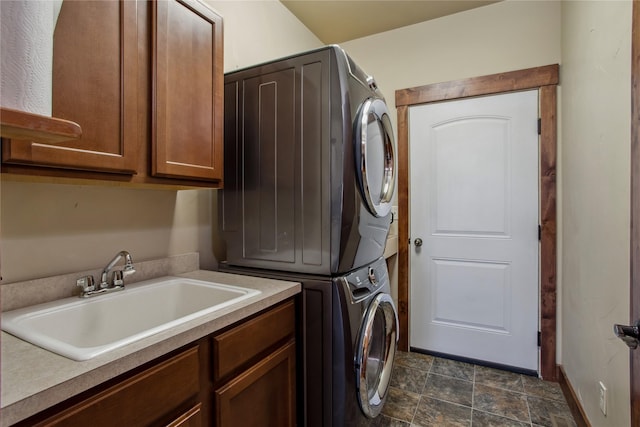 309 Timberwolf Dr, Polson, MT 59860 - laundry room with stacked washer / drying machine, cabinet space, and stone finish flooring