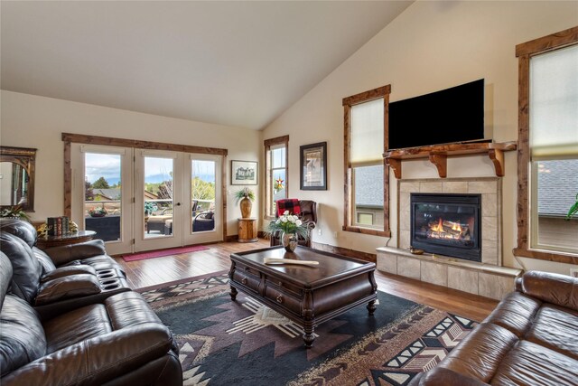 309 Timberwolf Dr, Polson, MT 59860 - living room featuring hardwood / wood-style floors, a fireplace, french doors, and high vaulted ceiling