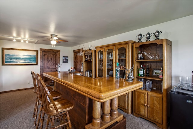 309 Timberwolf Dr, Polson, MT 59860 - indoor bar featuring refrigerator, ceiling fan, and carpet floors