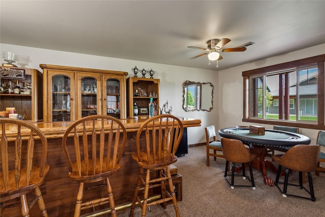 309 Timberwolf Dr, Polson, MT 59860 - carpeted dining space featuring a bar, a ceiling fan, and baseboards