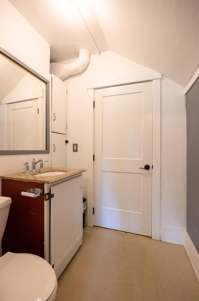 831 Hastings Ave, Missoula, MT 59801 - bathroom featuring lofted ceiling, toilet, and vanity