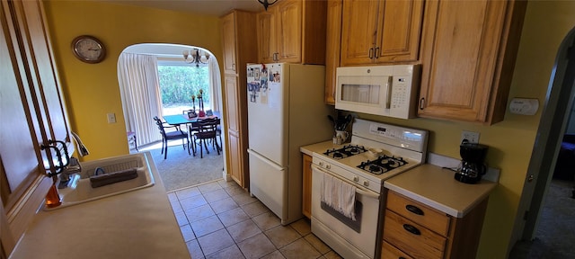 225 4th Ave SE, Dutton, MT 59433 - kitchen featuring white appliances, light countertops, light carpet, a chandelier, and brown cabinets