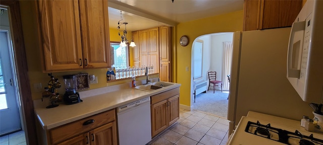 225 4th Ave SE, Dutton, MT 59433 - kitchen featuring white appliances, light tile patterned flooring, light countertops, hanging light fixtures, and brown cabinetry