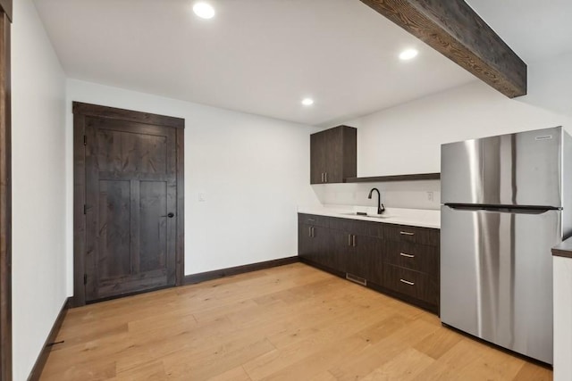 1942 Whitefish Ave, Whitefish, MT 59937 - kitchen featuring freestanding refrigerator, dark brown cabinetry, light countertops, light wood-style floors, and recessed lighting