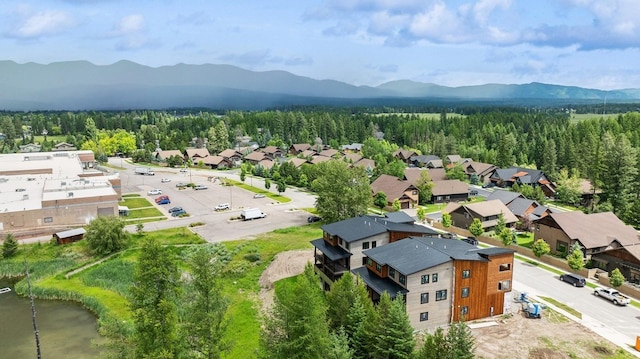 1942 Whitefish Ave, Whitefish, MT 59937 - aerial perspective of suburban area featuring a mountainous background and a heavily wooded area