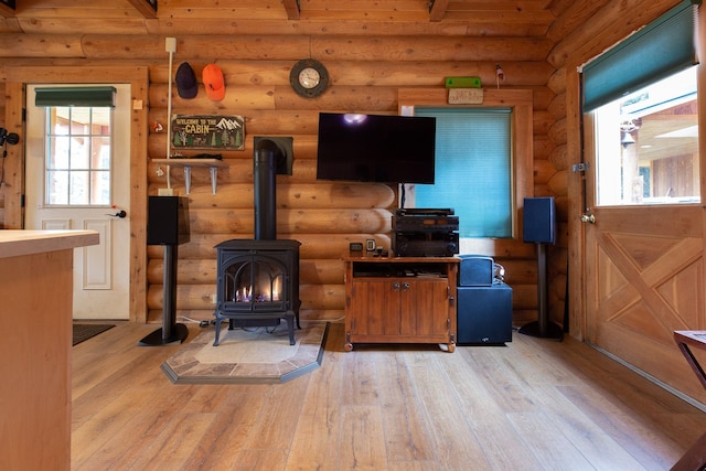 589 Summit Dr, Seeley Lake, MT 59868 - living area featuring a wood stove, hardwood / wood-style flooring, and rustic walls