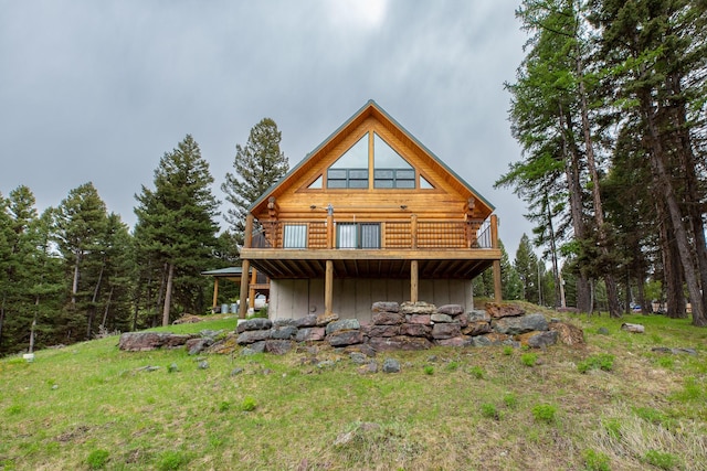 589 Summit Dr, Seeley Lake, MT 59868 - rear view of house with log exterior, a deck, and board and batten siding