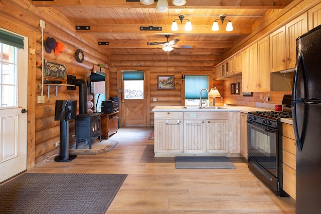 589 Summit Dr, Seeley Lake, MT 59868 - kitchen featuring a wooden ceiling with exposed beams, black appliances, rustic walls, light wood-style flooring, and a peninsula
